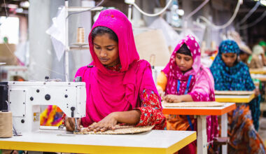 Women working on a sewing machine in a factory in Bangladesh