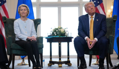 President of the European Commission Ursula von der Leyen meets with U.S. President Donald Trump as they both sit smiling facing look away from each other, at Trump Turnberry golf club in Turnberry, Scotland.
