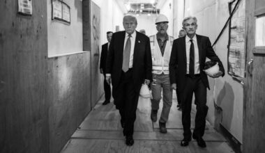 A black and white photograph of President Donald Trump touring the Federal Reserve alongside Fed Chair Jerome Powell and Sen. Tim Scott, Washington DC, USA.
