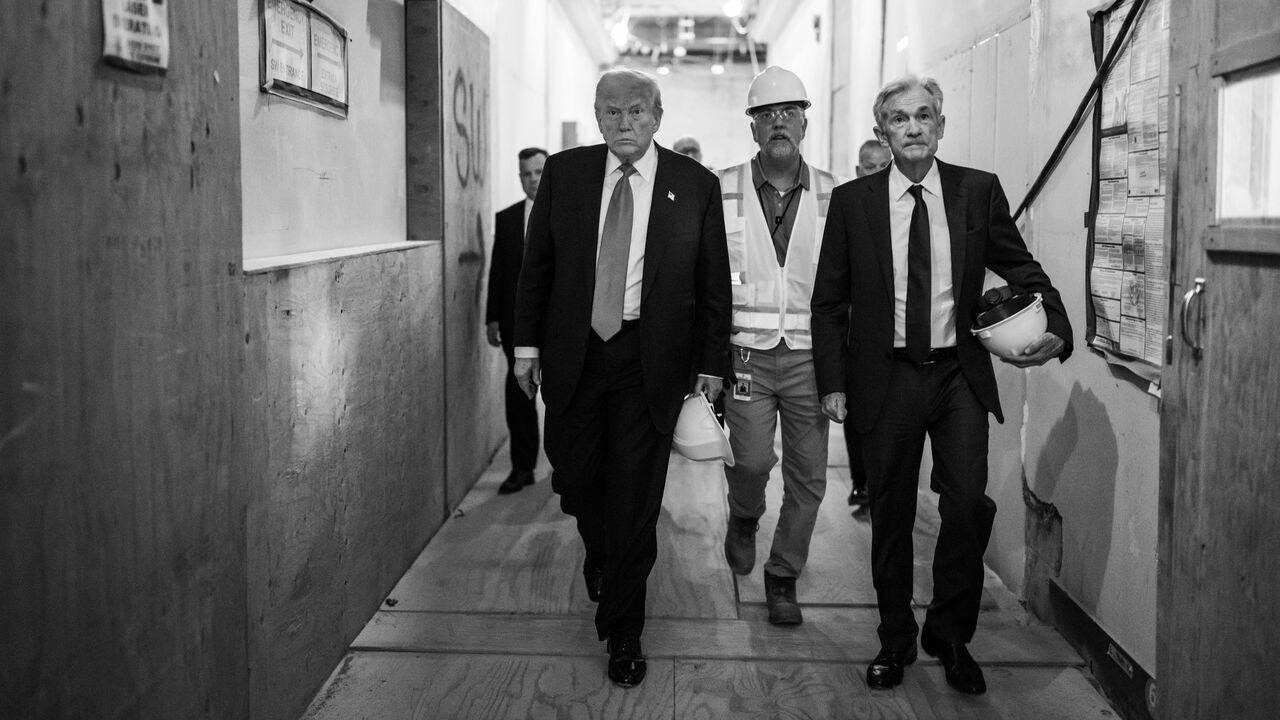 A black and white photograph of President Donald Trump touring the Federal Reserve alongside Fed Chair Jerome Powell and Sen. Tim Scott, Washington DC, USA.