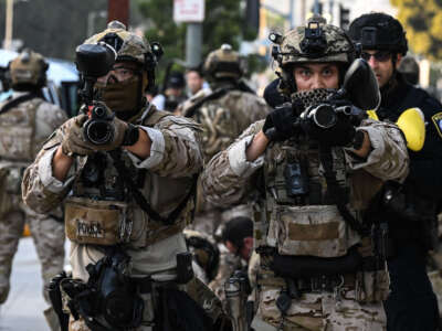 U.S. Customs and Border Protection agents hold up "less-lethal" weapons in front of the Federal Building during ongoing demonstrations in response to federal immigration operations in downtown Los Angeles on June 12, 2025.
