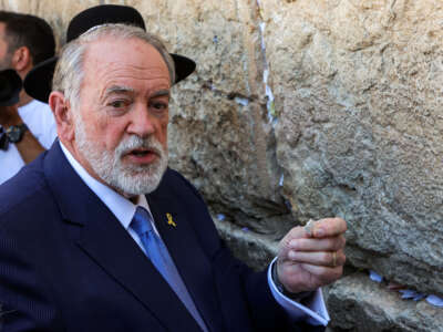 The U.S.' new ambassador to Israel Mike Huckabee holds a note given to him from President Donald Trump to be placed in the cracks of the Western Wall, the holiest site where Jews are allowed to pray, during Huckabee's visit to the holy site in the old city of Jerusalem on April 18, 2025.