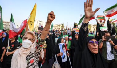 Iranians chant slogans and wave national flags as they celebrate a ceasefire between Iran and Israel at Enghlab Square in Tehran on June 24. A fragile ceasefire in the Iran-Israel war appeared to be holding on June 24, after 12 days of strikes that saw Israel and the United States pummel the Islamic republic's nuclear facilities.