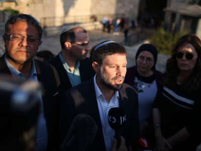 Member of the Knesset (Israel's parliament) from religious Zionist parties, Bezalel Smotrich speaks to a journalist as fellow Knesset member Itamar Ben Gvir (left) looks on, outside the Damascus Gate in Jerusalem, on October 20, 2021.