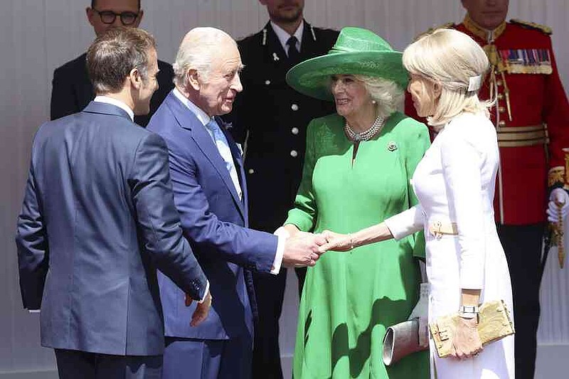 Britain's King Charles III and Queen Camilla welcome France's President Emmanuel Macron, left, and his wife Brigitte Macron, right, in Windsor, England, Tuesday July 8, 2025, on the first day of a three-day state visit to Britain. (Chris Jackson/Pool via AP)