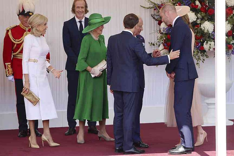 Britain's King Charles III, 3rd right, Queen Camilla, center left, Prince William, second right, and Kate, Princess of Wales, right, welcome France's President Emmanuel Macron, 4th right, and his wife Brigitte Macron, left, in Windsor, England, Tuesday July 8, 2025, on the first day of a three-day state visit to Britain. (Chris Jackson/Pool via AP)