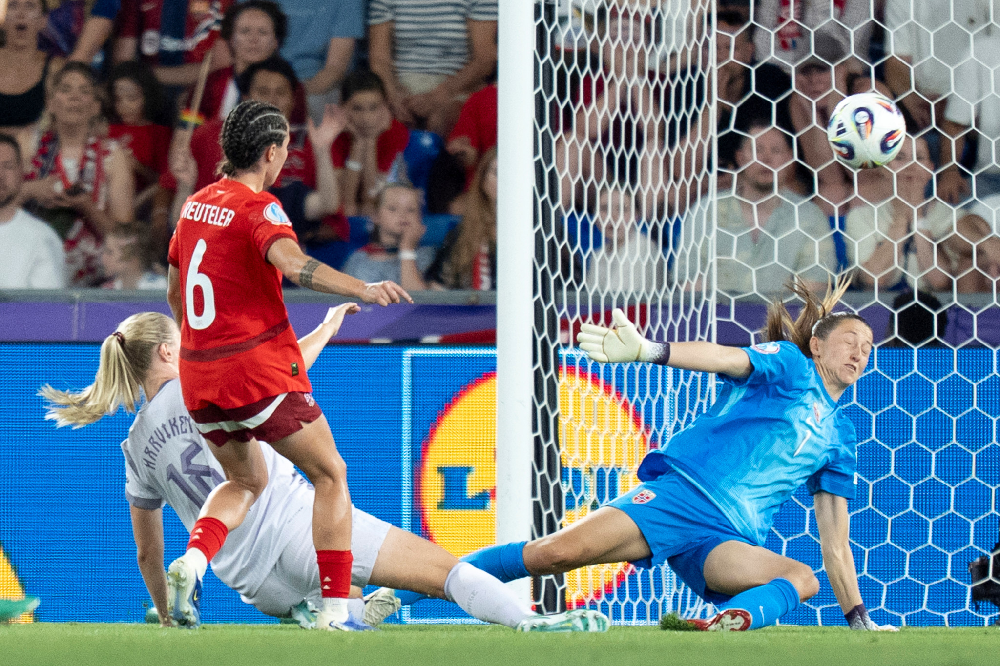 Geraldine Reuteler de la Suisse bat Mathilde Harviken de la Norvège pendant un match de l’EURO féminin 2025, la gardienne Cecilie Fiskerstrand tente un arrêt.