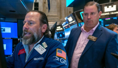 Wall Street edges back from its records as a busy week picks up momentum