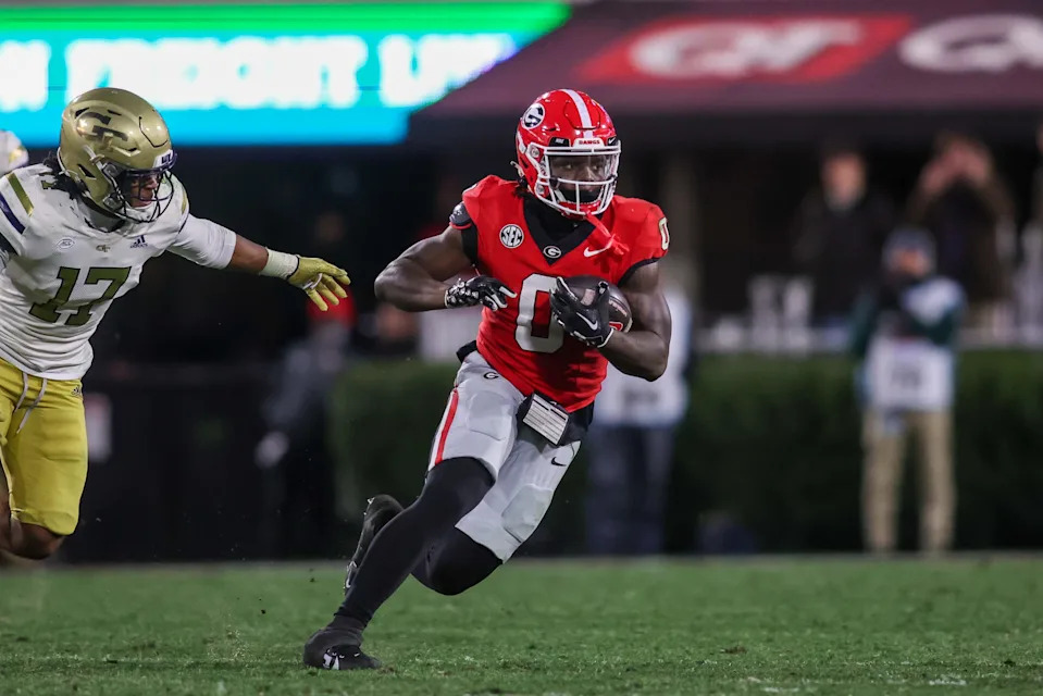 Nov 29, 2024; Athens, Georgia, USA; Georgia Bulldogs running back Roderick Robinson II (0) runs the ball against the Georgia Tech Yellow Jackets in the fourth quarter at Sanford Stadium.