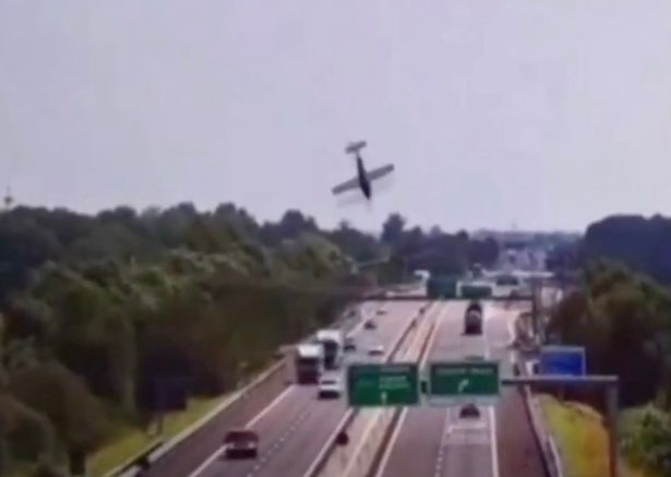 A plane careers nose-down towards the highway, which is busy with cars