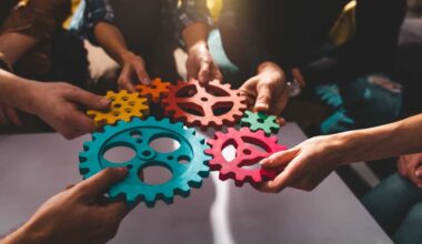 shutterstock 2270669753 teamwork concept team putting colored gears together