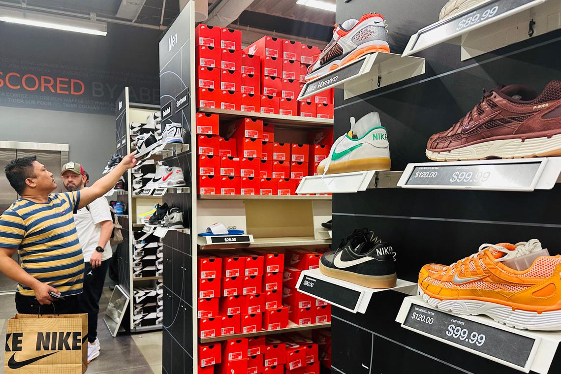 A man shops for shoes from a Nike store at an outlet in Los Angeles, California on April 10, 2025. Trump on April 9 announced a 90-day pause on the most onerous new tariffs on imports to the United States for every country except China. Americans spend about $31 billion on sneaker brands with almost all sneakers in the US market coming from Asian countries of Vietnam, China, Indonesia and Cambodia, as Trump tariffs impose a new consumption tax of at least 42% on most inbound sneakers to the United States. (Photo by Frederic J. BROWN / AFP)