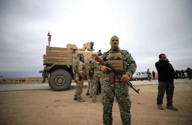SYRIAN DEMOCRATIC FORCES and US troops are seen during a patrol near Turkish border in Hasakah, Syria, in November. (credit: RODI SAID / REUTERS)