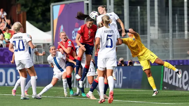 Ingrid Syrstad Engen of Norway creates a headed chance, as Anna Koivunen of Finland attempts to make the save during the UEFA Women's EURO 2025 Group A match between Norway and Finland at Stade de Tourbillon