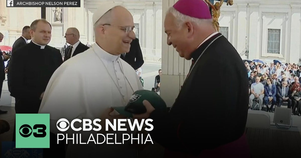Pope Leo XIV receives an Eagles Super Bowl hat from Archbishop Nelson Pérez during meeting