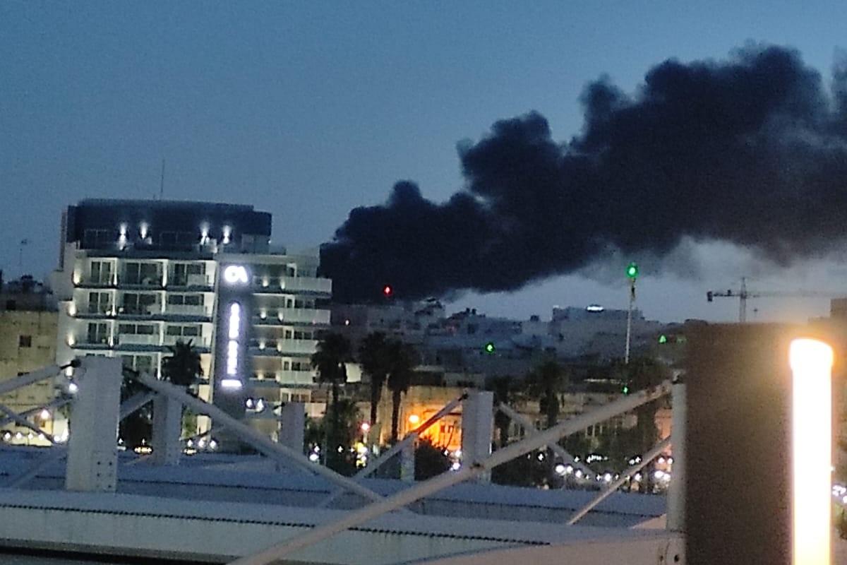 A thick black plume of smoke could be seen from a distance as a fire raged in two factories in Ħal Far. A thick black plume of smoke could be seen from a distance as a fire raged in two factories in Ħal Far.