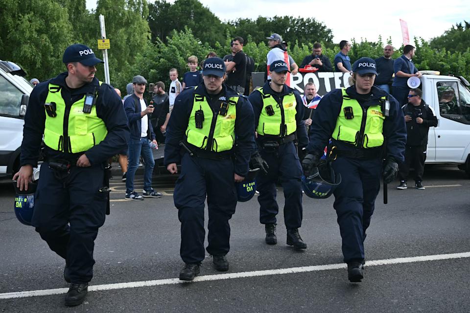 Police officers with riot gear secure an anti-immigration protest outside The Bell Hotel, believed to be housing asylum seekers, in Epping, northeast of London on July 20, 2025. The protest follows several demonstrations in recent days outside the town's Bell Hotel, one of which turning violent, which flared after police charged an asylum-seeker with sexual offences following an incident earlier this month. (Photo by JUSTIN TALLIS / AFP) (Photo by JUSTIN TALLIS/AFP via Getty Images)          