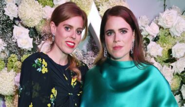 Princess Beatrice and Princess Eugenie pose smiling at the camera together