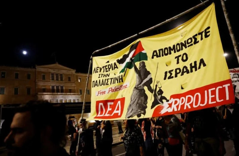 Protesters hold a banner during a pro-Palestinian protest in front of the parliament building in Athens, Greece. (credit: REUTERS/LOUIZA VRADI)