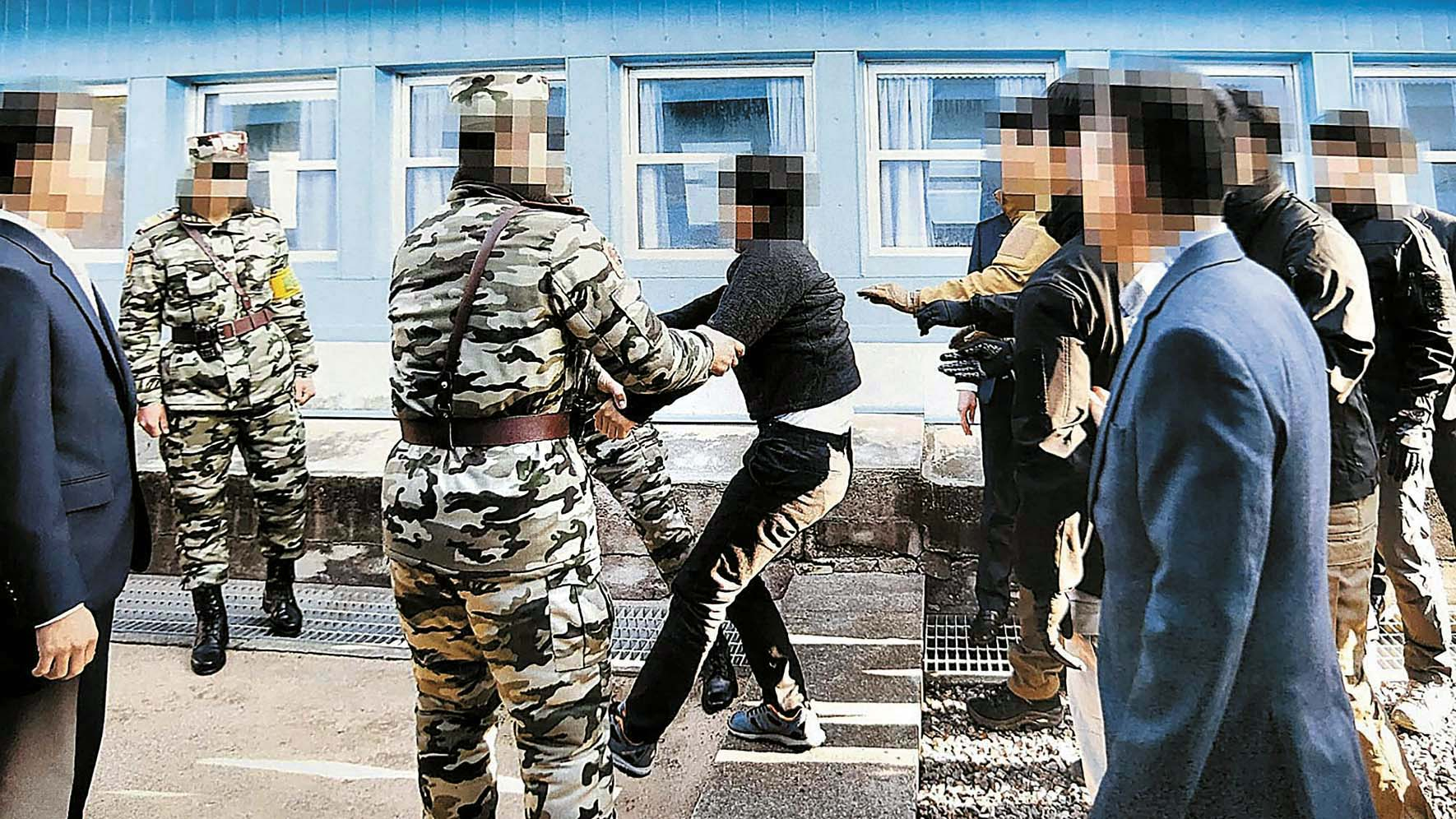 A North Korean fisherman resists repatriation at Panmunjom in November 2019 who was forcibly returned to the North after allegedly murdering 16 crewmates. The men expressed intent to defect but were deported within five days. [MINISTRY OF UNIFICATION]