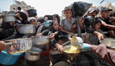 Palestinians gather to receive food from a charity kitchen in Gaza on July 28.