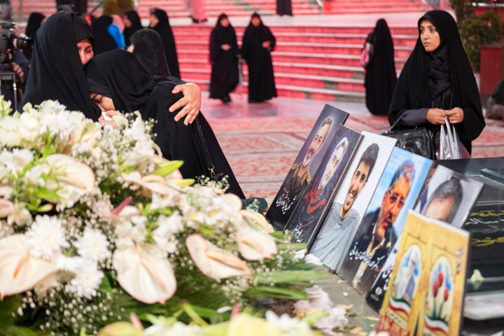 Iranian women mourn beside the graves of a general and nuclear scientists who were killed in Israeli attacks, at a holy shrine in northern Tehran, on June 30, 2025.