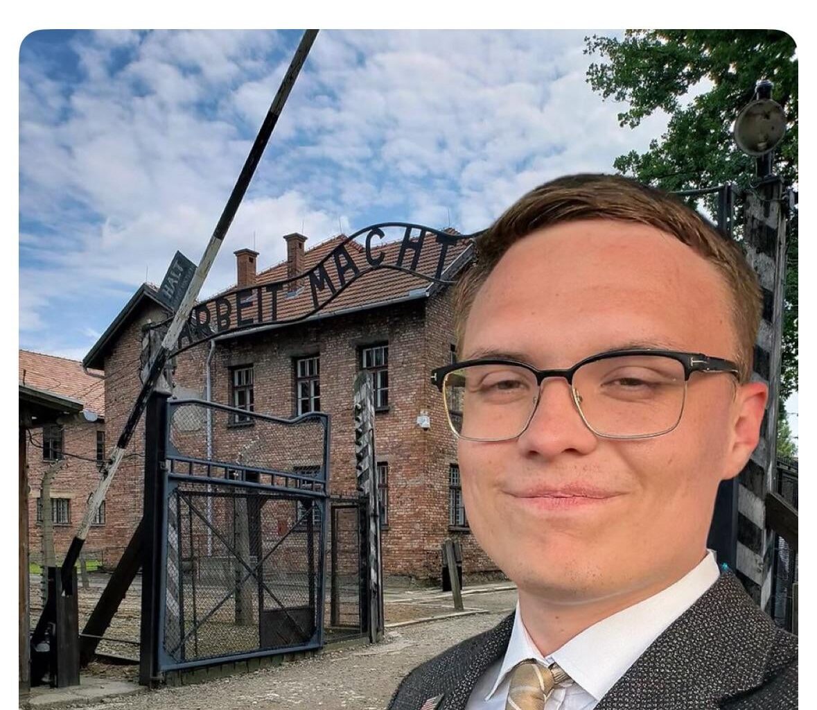 Republican candidate for Governor of California Kyle Langford poses in front of Nazi concentration camp and suggests he will send unemployed & homeless there to be incinerated