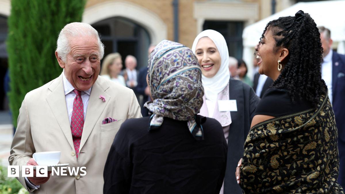 King Charles meets staff during a visit to the Oxford Centre for Islamic Studies in Oxford.