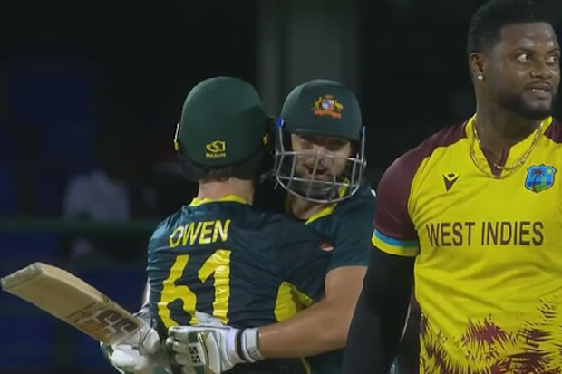 Tim David celebrates bringing up his century and completing victory for Australia.
