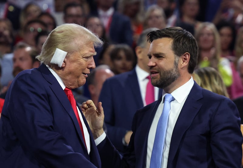Republican presidential nominee and former U.S. President Donald Trump and Republican vice presidential nominee J.D. Vance interact during Day 1 of the Republican National Convention.