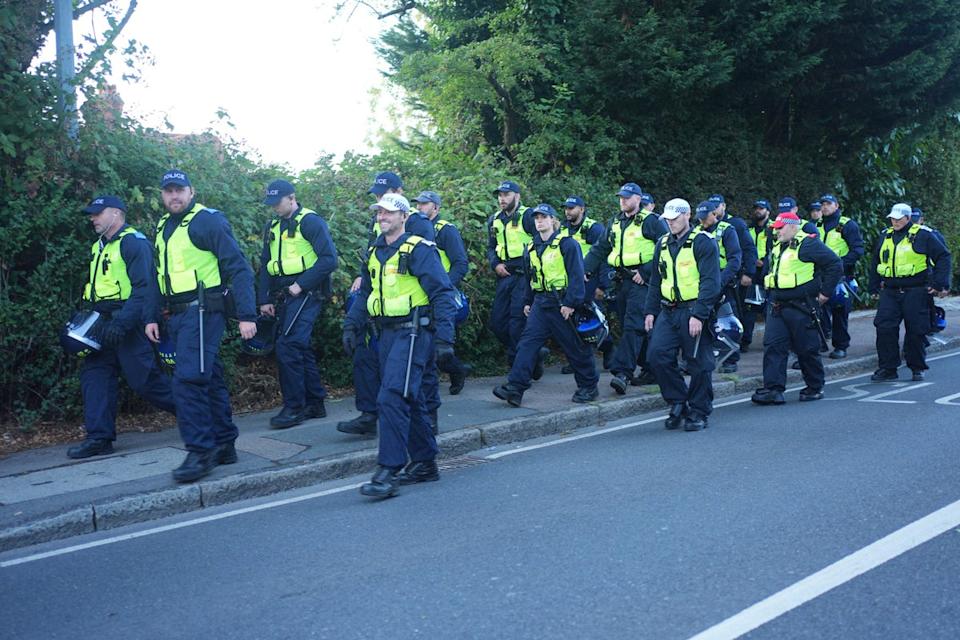 Police assemble near the Bell Hotel in Epping, Essex (PA)
