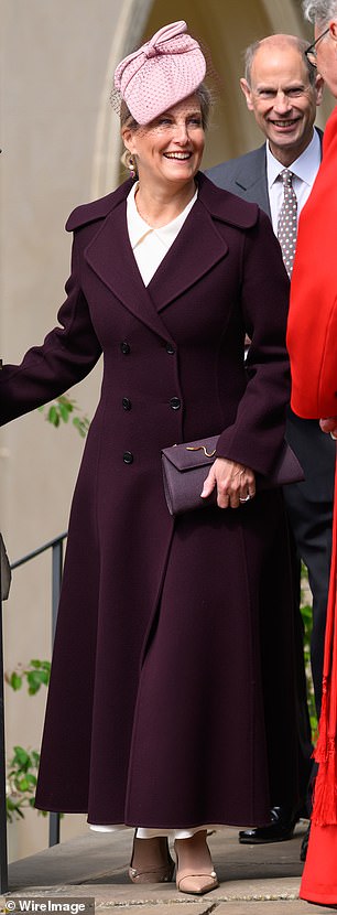 The royal matched her clutch with gold details to her coat but opted for a playful contrast with a blush pink fascinator complete with contrasting veil