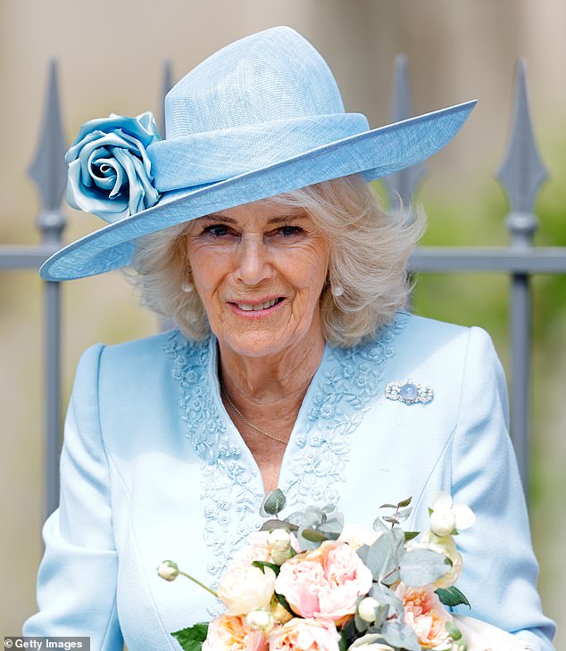 Queen Camilla, 77, looked radiant in a baby blue coat from Fiona Clare Couture which featured delicate floral embroidery around the collar and cuffs