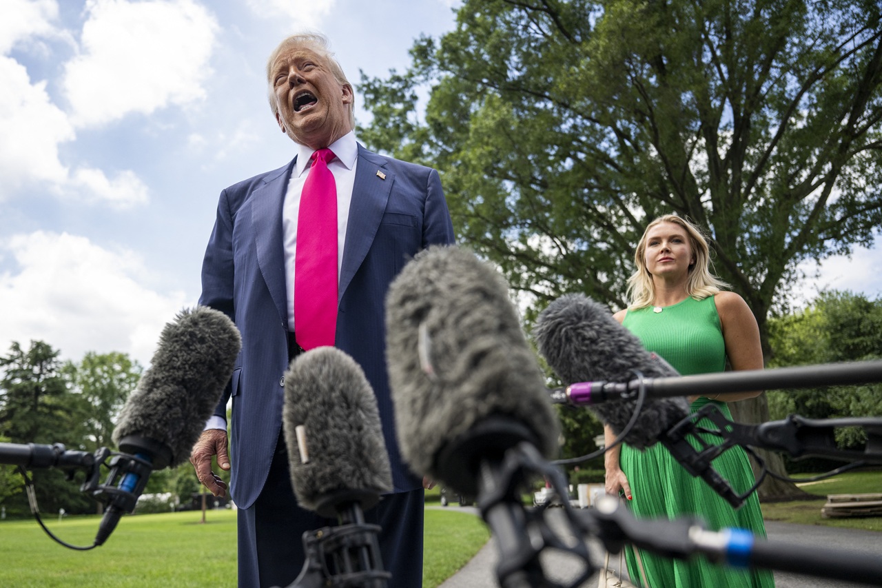 US President Donald Trump, alongside White House Press Secretary Karoline Leavitt, speaks to reporters on his way to board Marine One on the South Lawn of the White House on July 15, 2025, in Washington, DC.