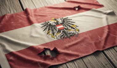 tattered Austrian flag on a wood floor