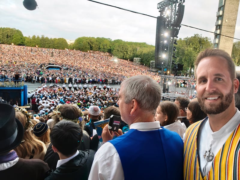 Lance McGavin snaps a photo while on stage during the Estonian Song Festival at the Tallinn Song Festival Grounds in Tallinn, Estonia, July 6, 2025.