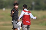 Luke Colton of Frisco shakes hand with his caddie after winning a quarterfinals match on the...