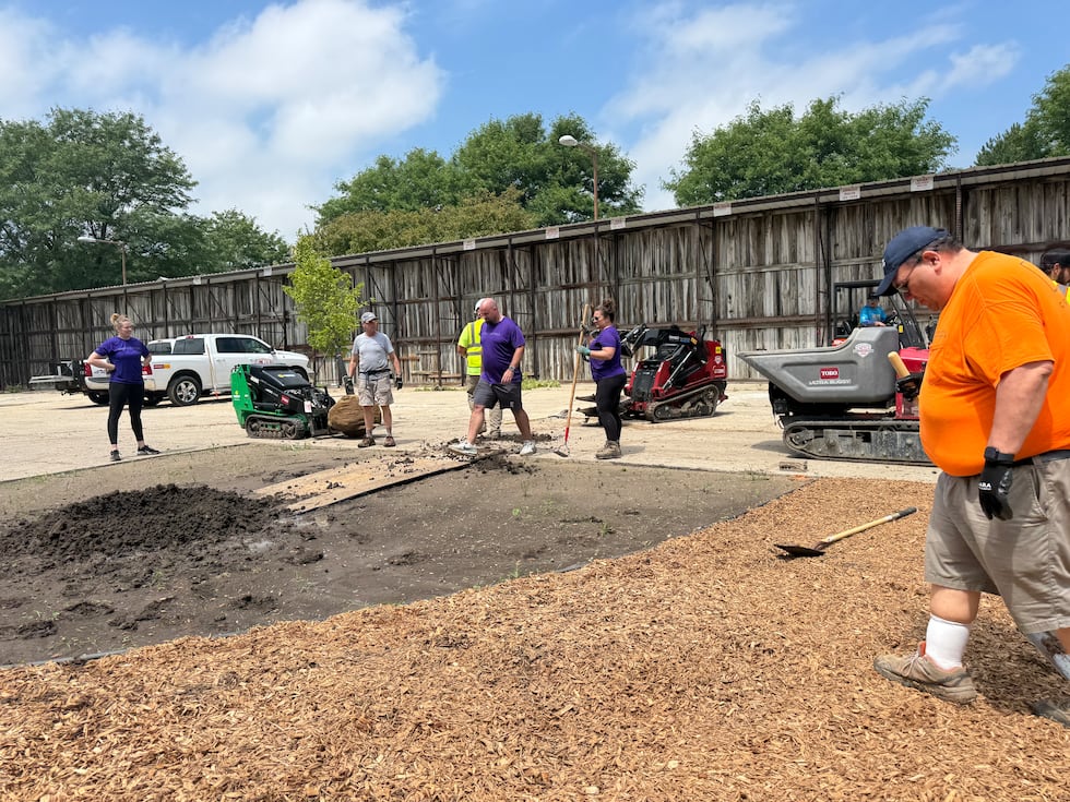 Volunteers getting ready to plant a tree for The Playing Field's new play area.