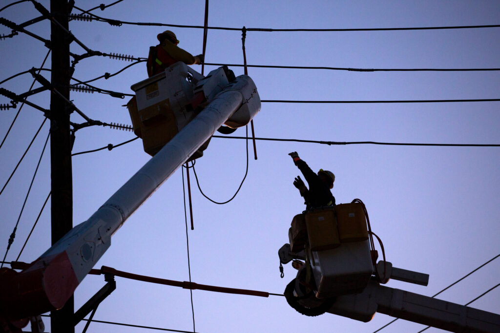 Utility workers repair a power line on Feb. 10, 2022, in Ridgefield N.J. Credit: EMAZ/VIEWpress via Getty Images
