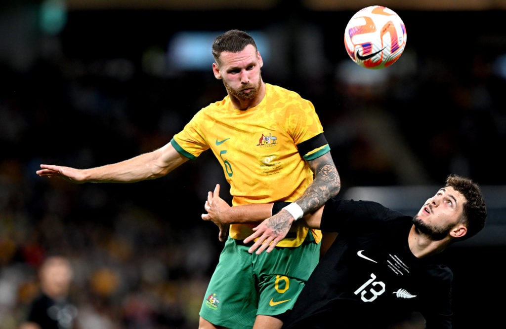 Martin Boyle of Australia and Liberato Cacace of New Zealand challenge