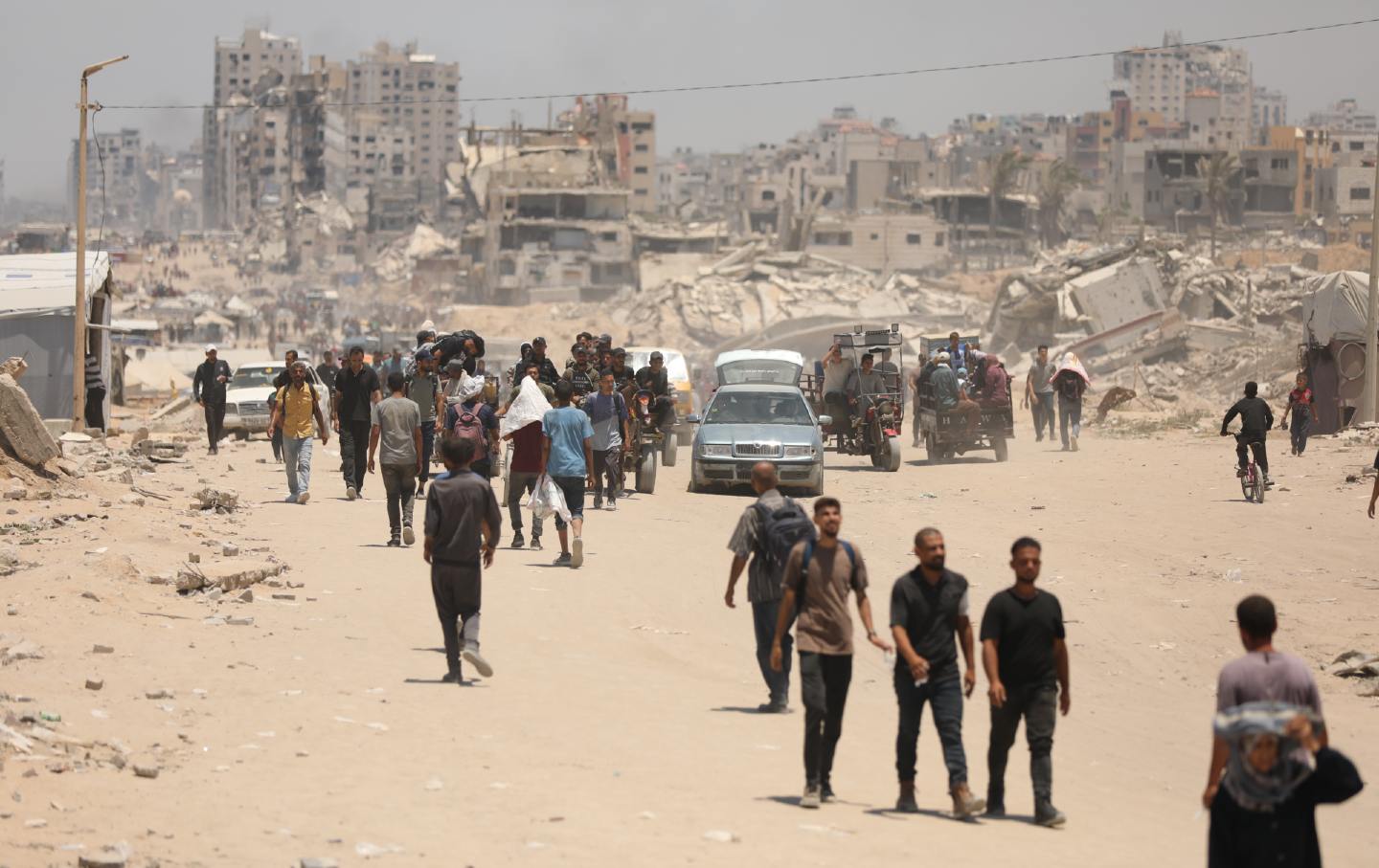 Palestinians walk toward the aid distribution point in the Netzarim Corridor in Gaza.