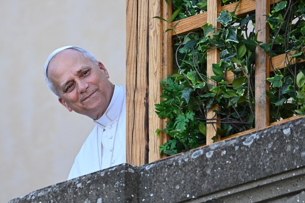 Pope Leo XIV looks at the people from the terrace of the summer papal estate in Castel Gandolfo on Sunday. 