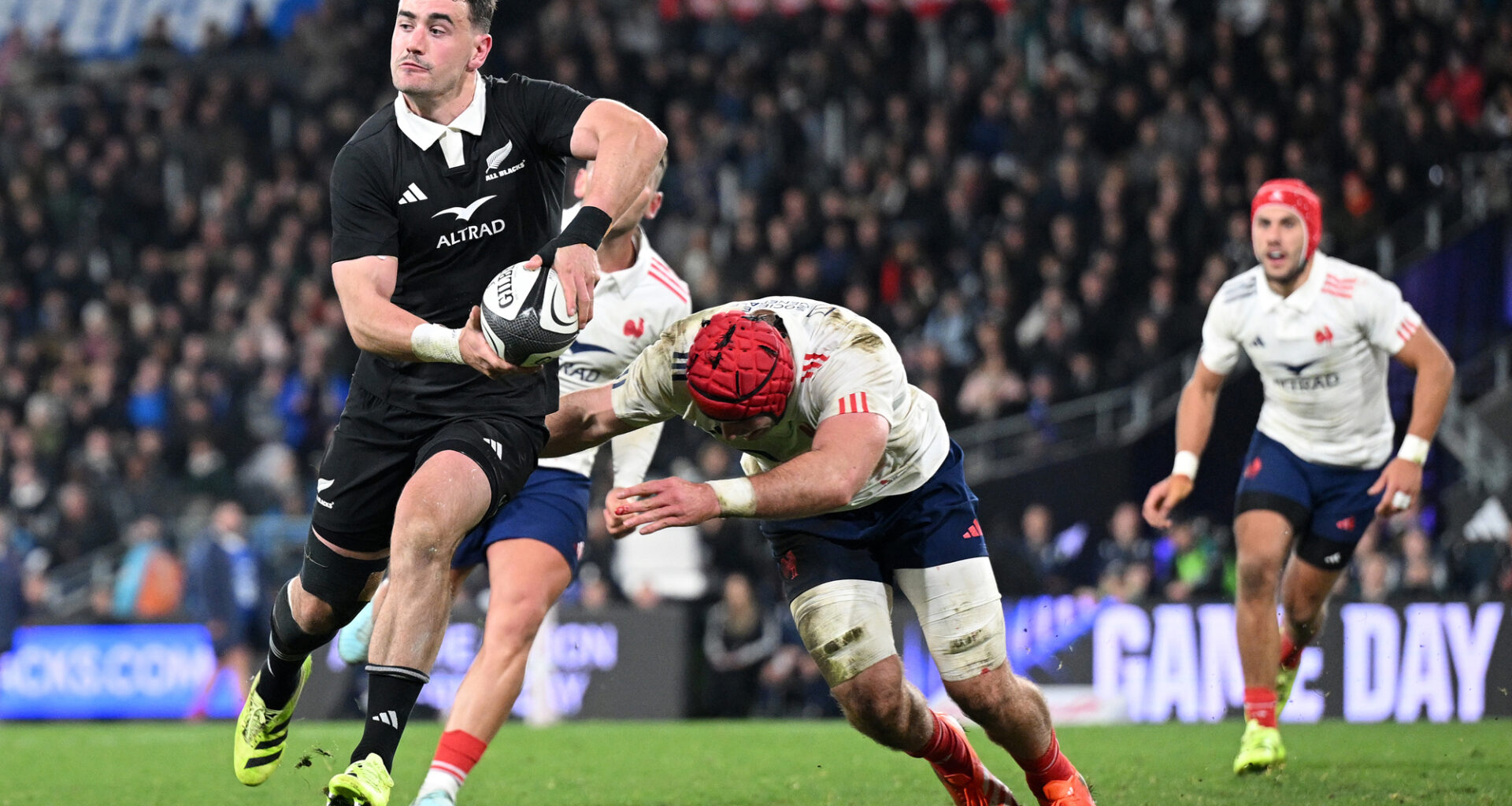 Will Jordan of New Zealand makes a pass as a France player attempts a tackle during the first July 2025 Test