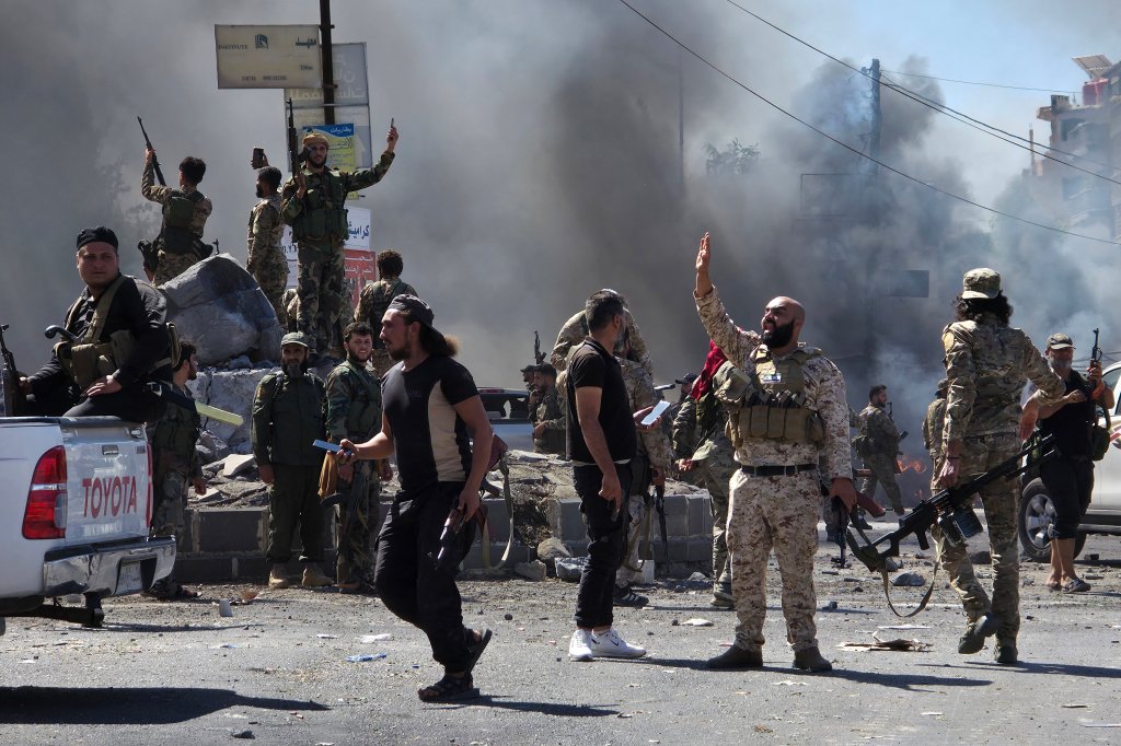 Syria's security forces enter the predominantly Druze city of Sweida on July 15, 2025, following clashes between Bedouin tribes and Druze fighters. Syrian government forces entered the majority Druze city of Sweida on July 15, 2025, the interior ministry said, aiming to end clashes with Bedouin tribes that have killed nearly 100 people. (Photo by Sam HARIRI / AFP) (Photo by SAM HARIRI/AFP via Getty Images)