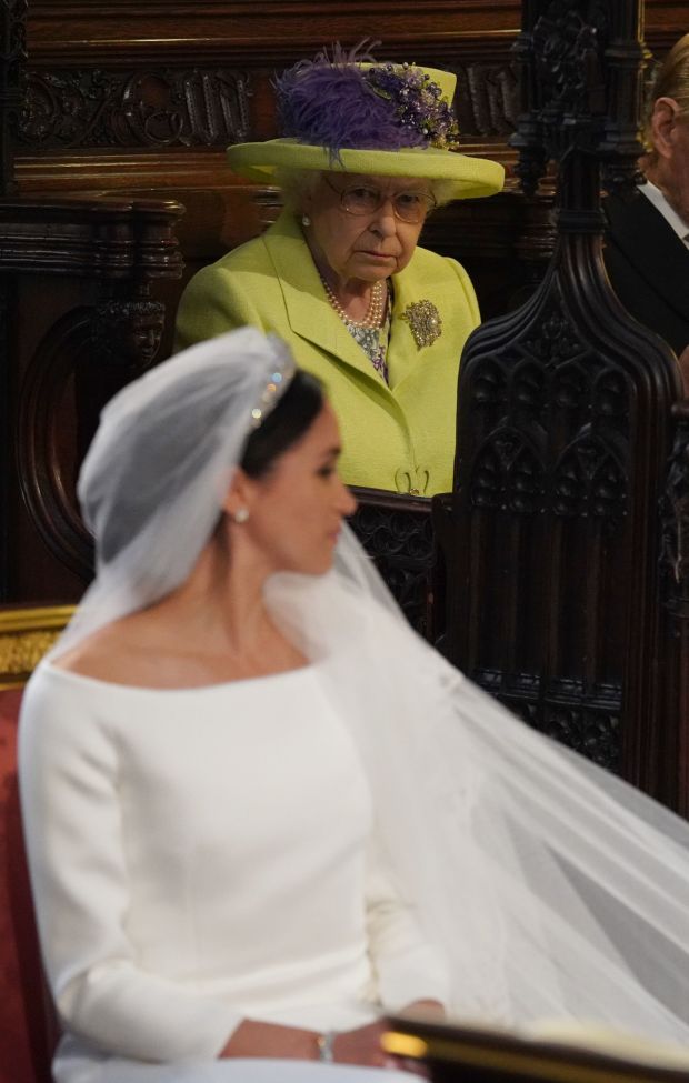 TOPSHOT - Britain's Queen Elizabeth II looks on during the wedding ceremony of Britain's Prince Harry, Duke of Sussex and US actress Meghan Markle in St George's Chapel, Windsor Castle, in Windsor, on May 19, 2018. (Photo by Jonathan Brady / POOL / AFP) (Photo credit should read JONATHAN BRADY/AFP via Getty Images)