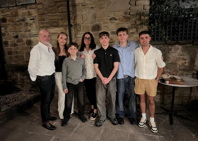 The Rushworth family take a picture together outside at night.