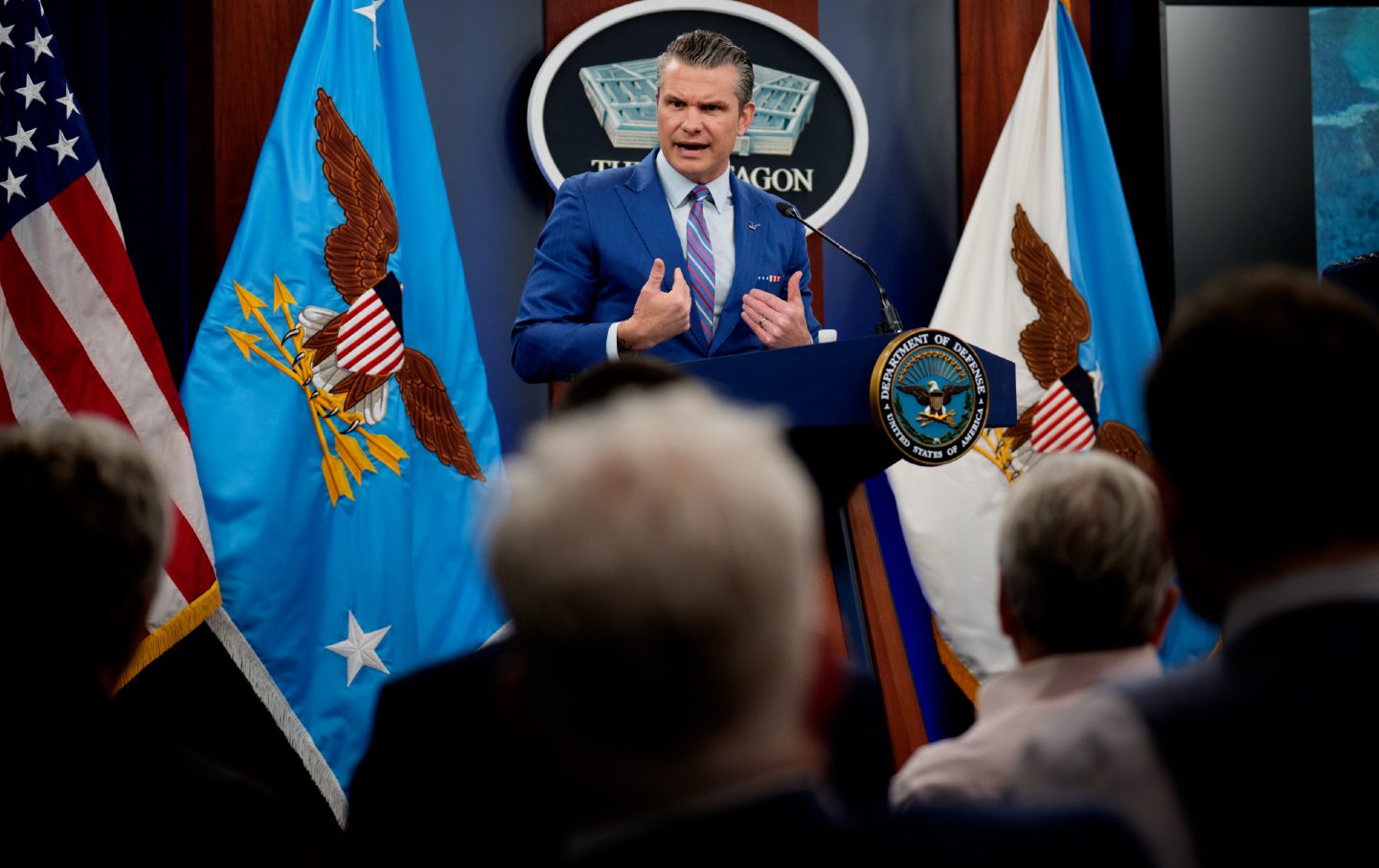 U.S. Defense Secretary Pete Hegseth speaks at a podium during a news conference.