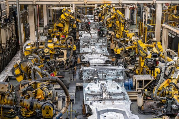 FILE - Robotic arms operate in a welding hall of the Suzuki manufacturing plant in Esztergom, northern Hungary, Oct. 19, 2022. (Zsolt Szigetvary/MTI via AP, File)