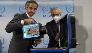 IAEA Director General Rafael Grossi demonstrates a surveillance camera used to monitor nuclear sites