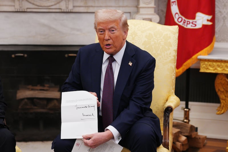 Trump brandishes a private letter from King Charles III to the cameras in a major breach of protocol and good manners.
